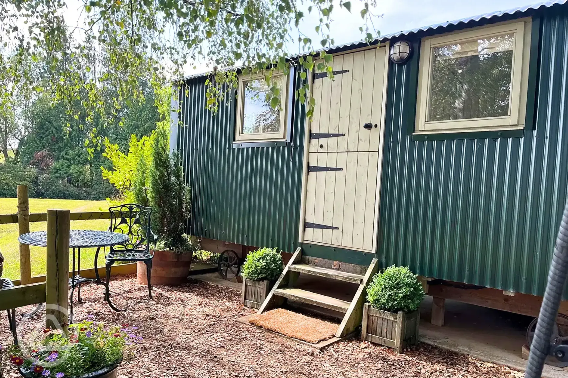 Shepherd's hut with a garden area and small step access