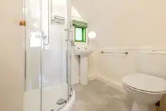 Bare Bones ensuite with a toilet, shower, sink and shaver socket Bare Bones ensuite with a toilet, shower, sink and shaver socket