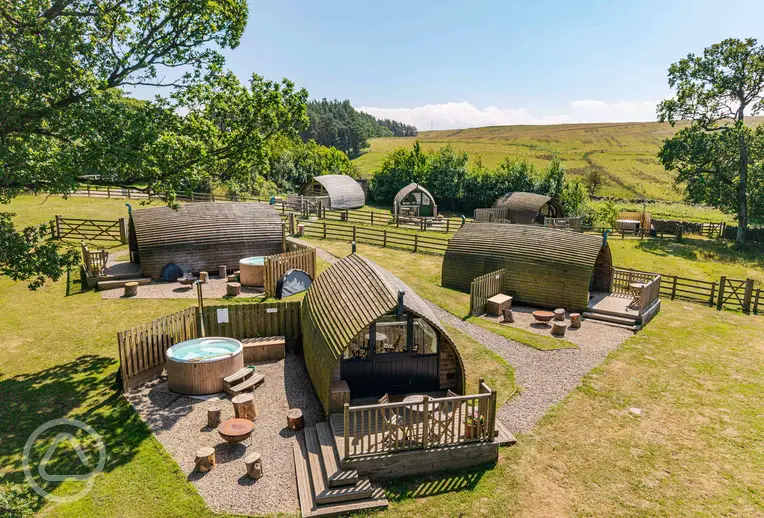 Glamping pods, some with optional wood-fired hot tubs