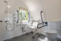 Humbleton accessible wet room with grab rails and a shower chair Humbleton accessible wet room with grab rails and a shower chair