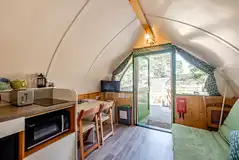 Bare Bones glamping pod kitchen, dining area and smart TV Bare Bones glamping pod kitchen, dining area and smart TV