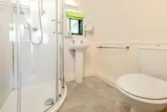 The Rushy Lot ensuite with a toilet, shower, sink and shaver socket The Rushy Lot ensuite with a toilet, shower, sink and shaver socket