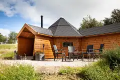 Each glamping cabin has a private outdoor seating area