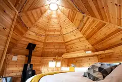 Glamping cabin interior with a wood burner