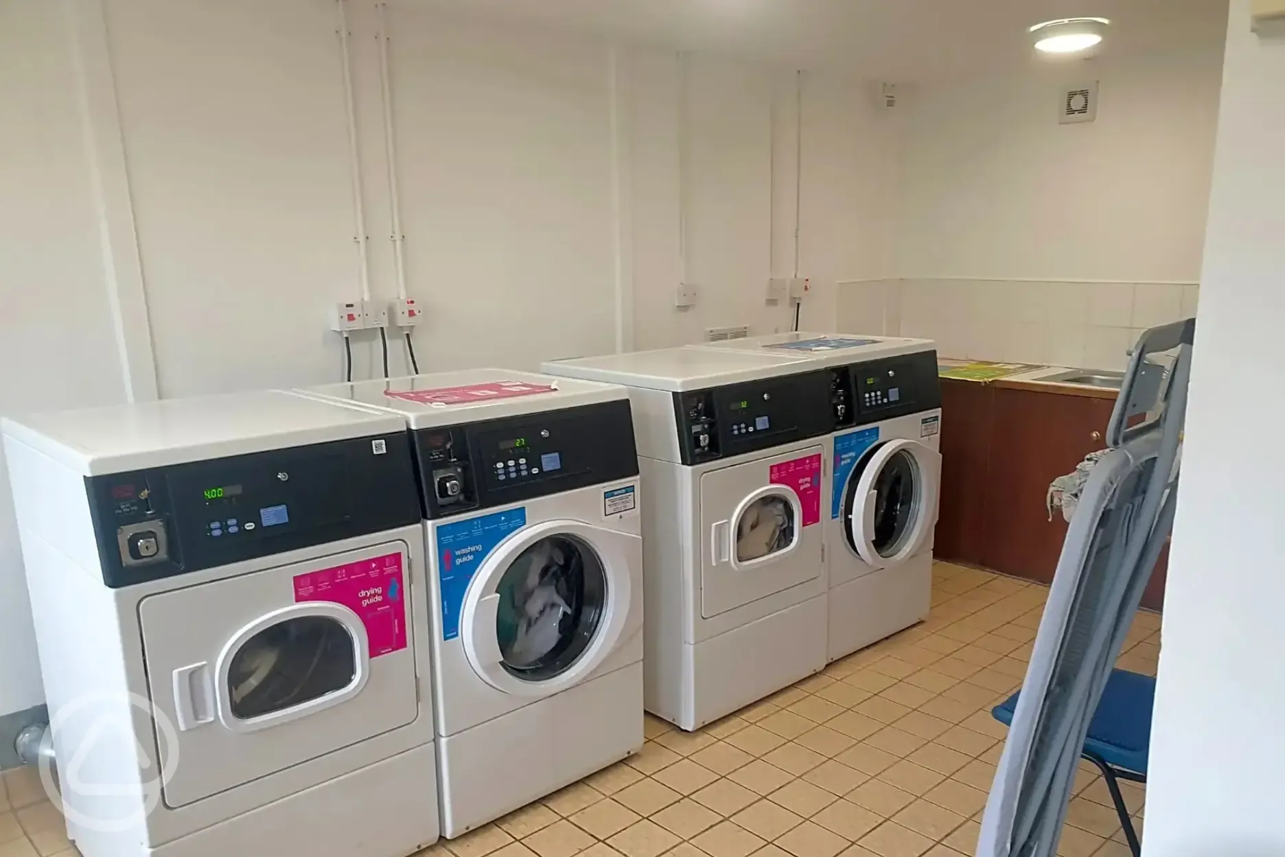 Two washing machine and dryers in the laundry room