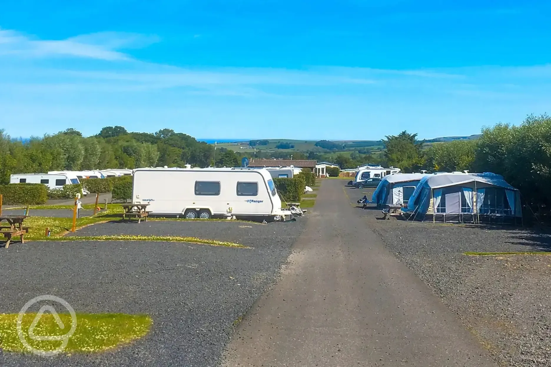 Tourers and awnings on electric hardstanding super pitches (9.1m x 7.6m)