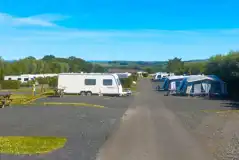 Tourers and awnings on electric hardstanding super pitches (9.1m x 7.6m)