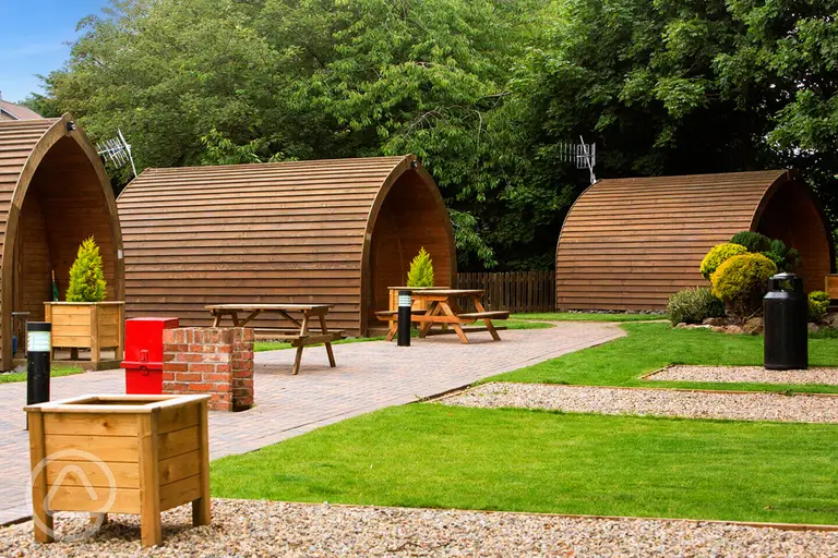 Camping pods with planting and grass areas