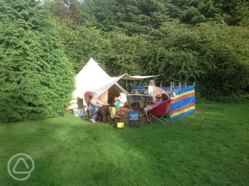 Campers outside bell tents