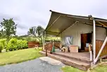 Safari tent with a deck area and outdoor furniture