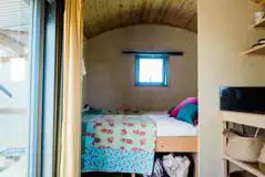Double bed in the beacon shepherd's hut interior