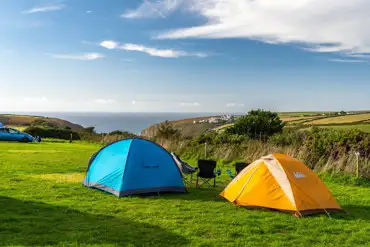 Grass pitches at Eco Park with a sea view of Porthtowan Beach