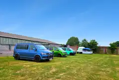 Campervans on the Robin electric grass pitches Campervans on the Robin electric grass pitches
