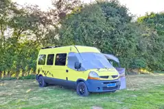 Campervan on a Rabbit non electric grass pitch backed by trees Campervan on a Rabbit non electric grass pitch backed by trees