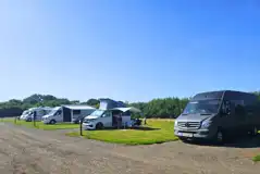 Badger large electric hardstanding and grass touring pitches at Manor Farm Badger large electric hardstanding and grass touring pitches at Manor Farm