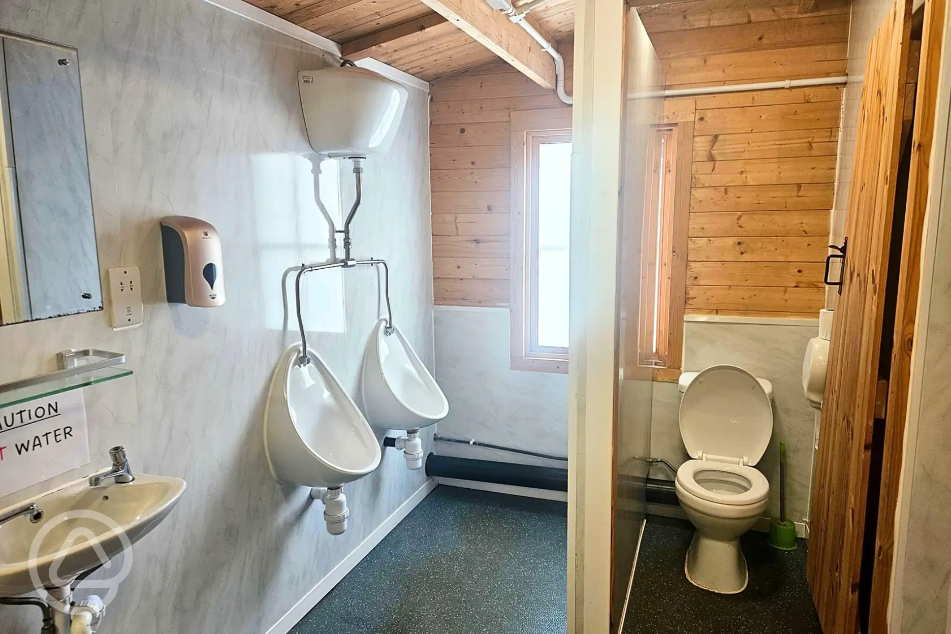 Male toilets with urinals, a cubicle, hand basin and shaving sockets