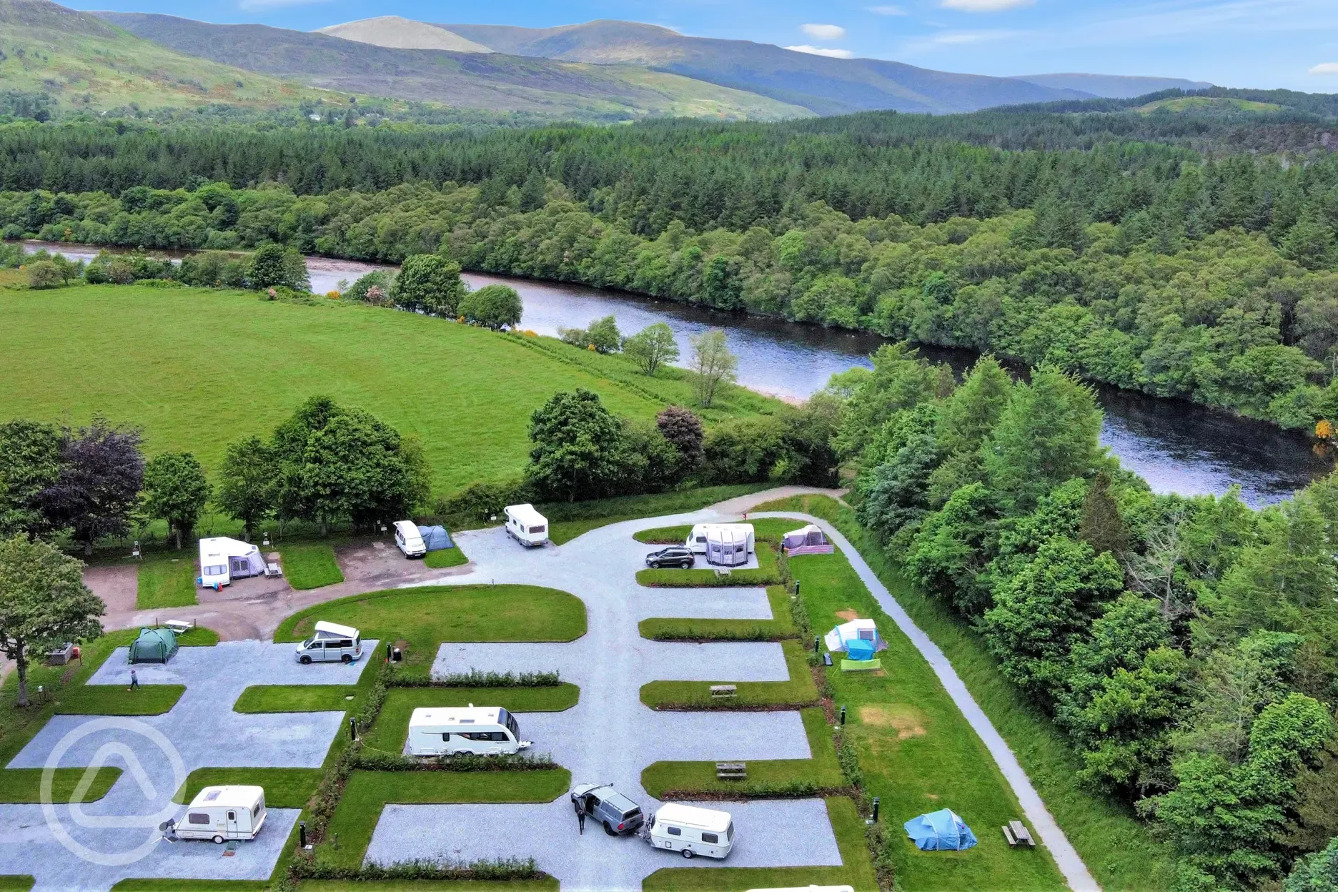Aerial of hardstanding pitches at Ben Nevis Holiday Park, surrounded by trees