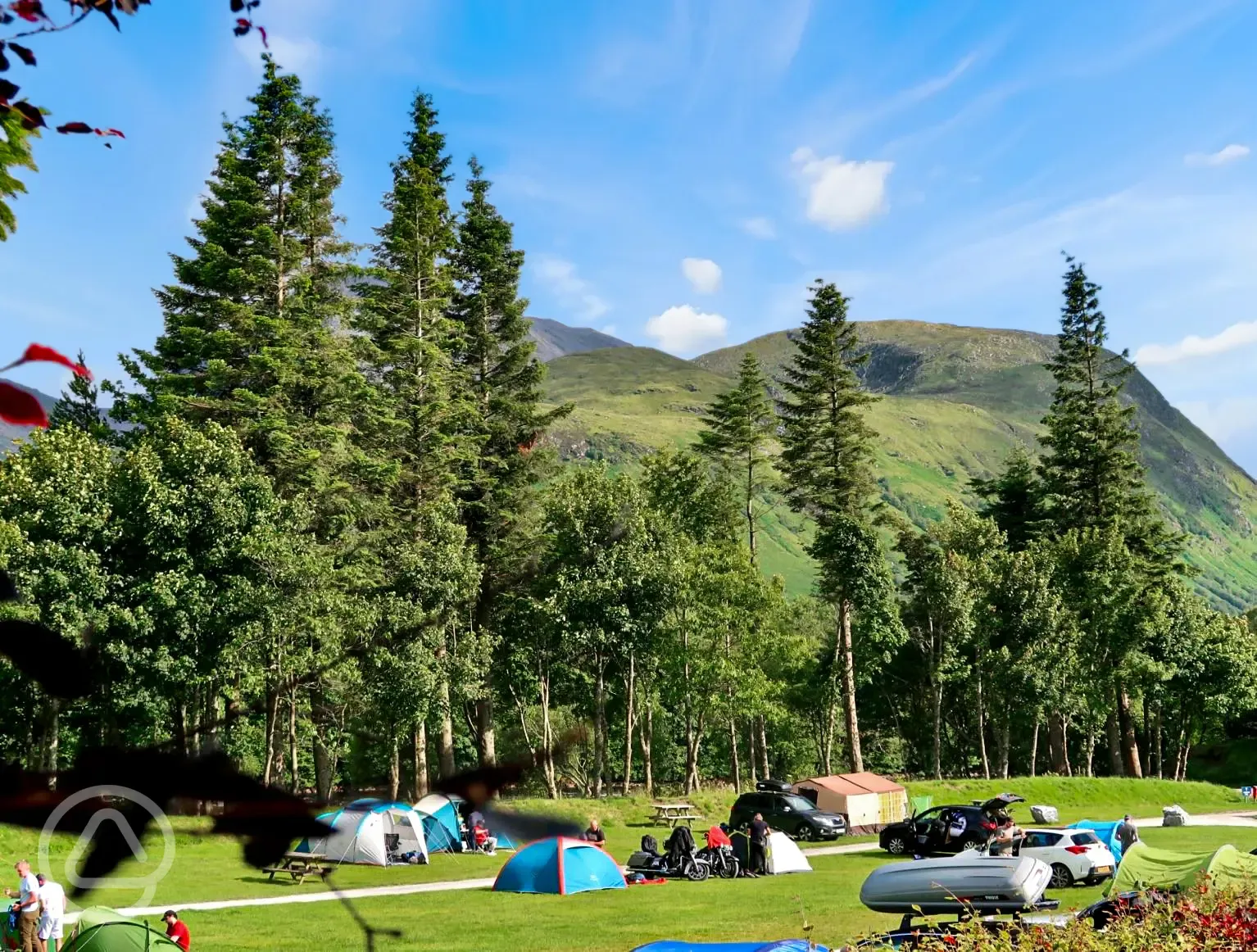 Grass pitches with mountain views at Ben Nevis Holiday Park
