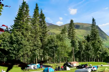 Grass pitches with mountain views at Ben Nevis Holiday Park