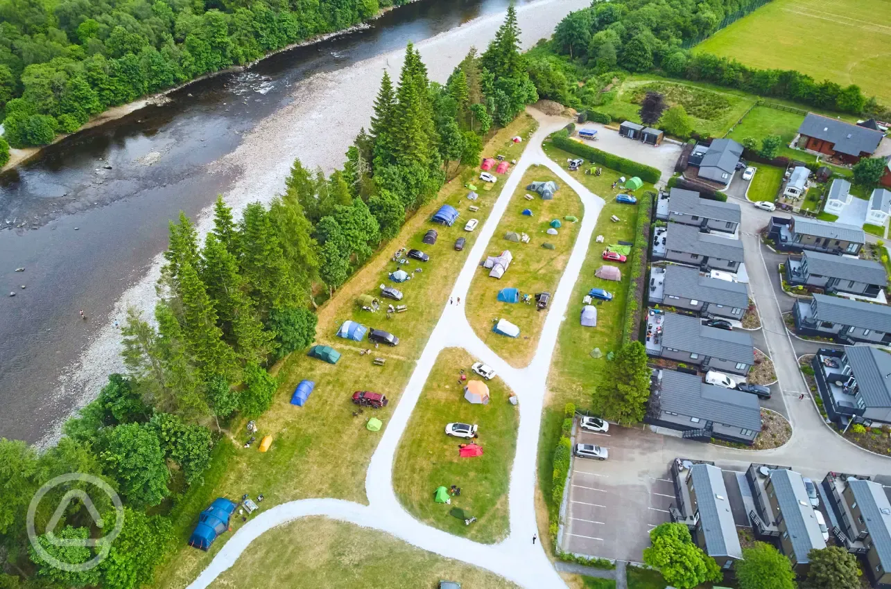 Aerial of grass pitches, holiday lodges and the River Lochy 