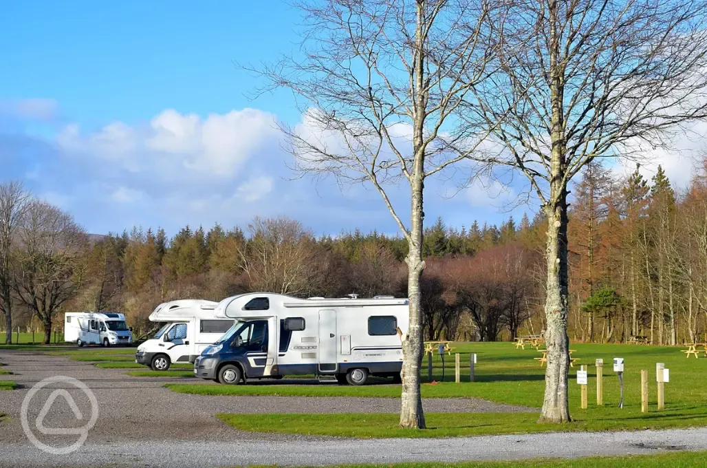 Electric hardstanding pitches for tourers, surrounded by trees