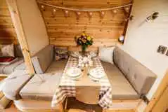 Glamping pod interior- dining table that converts into a bed