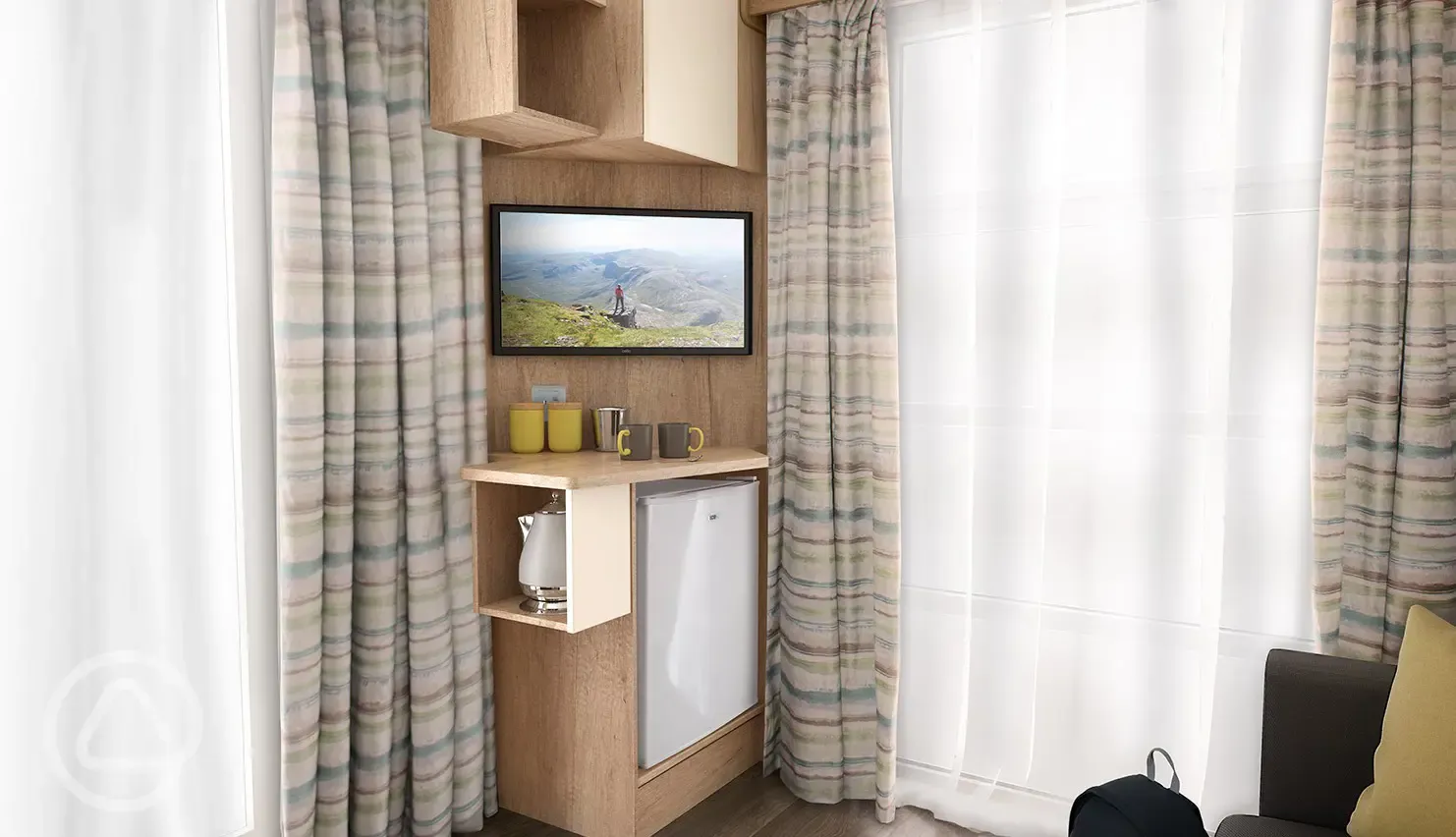 Studio pod cabin living area TV with a stored mini-fridge, kettle and crockery Studio pod cabin living area TV with a stored mini-fridge, kettle and crockery