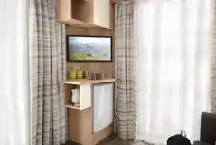Studio pod cabin living area TV with a stored mini-fridge, kettle and crockery Studio pod cabin living area TV with a stored mini-fridge, kettle and crockery