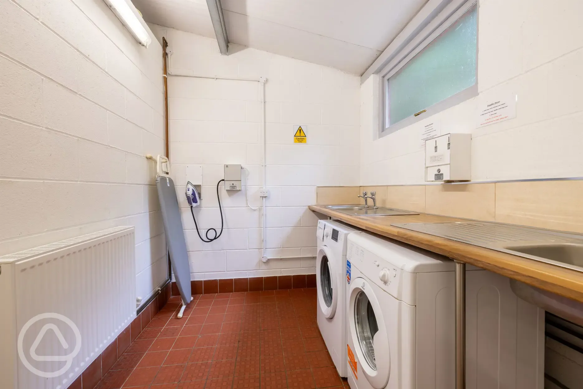 Heated laundry area with washing machine, tumble dryer, iron and ironing board Heated laundry area with washing machine, tumble dryer, iron and ironing board
