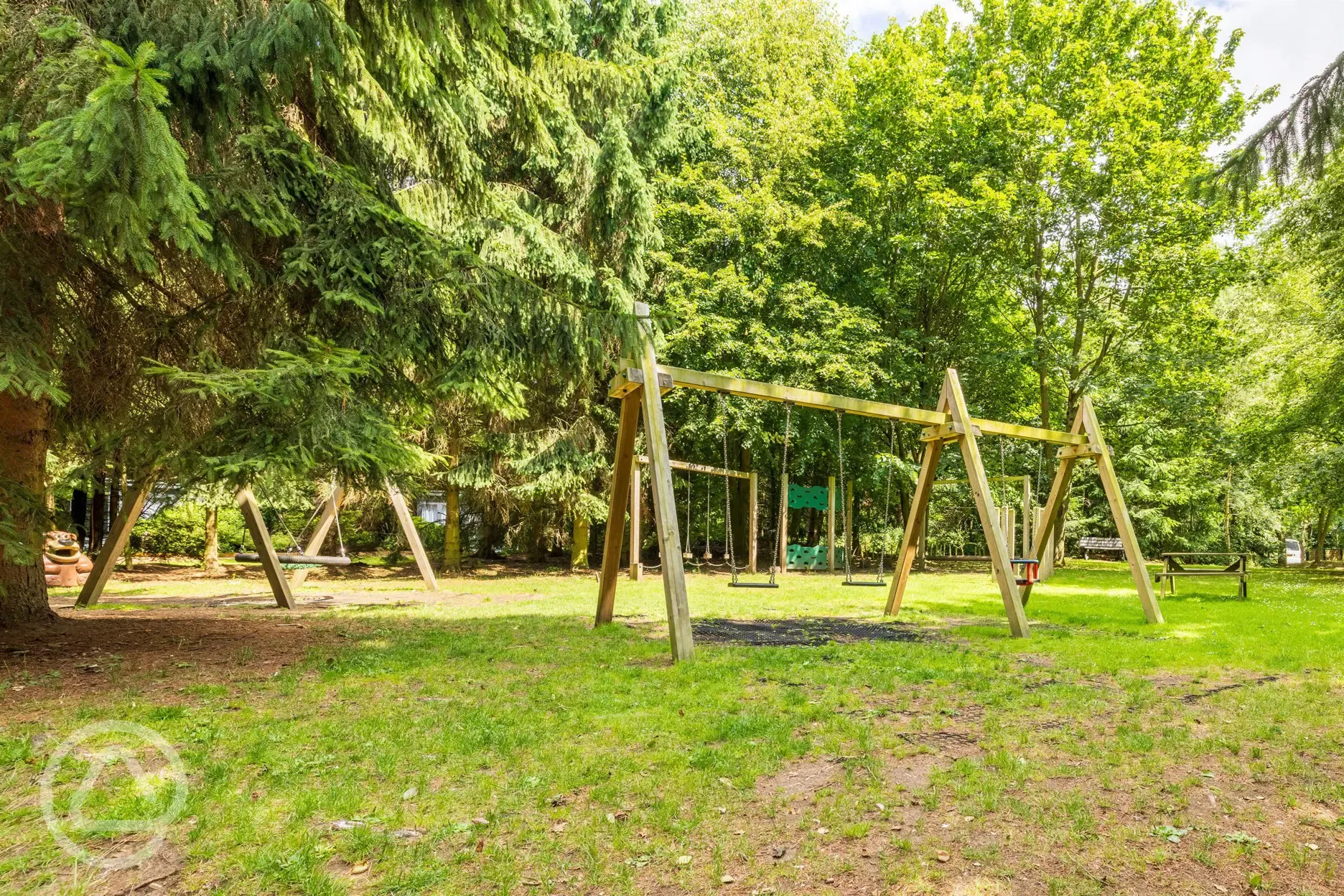Children's play area with swings and climbing frames at Nurseries Caravan Park Children's play area with swings and climbing frames at Nurseries Caravan Park