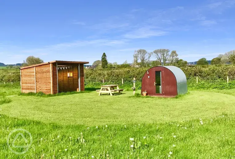 Fox Barn pod with a covered kitchen area at Big Barn Camping