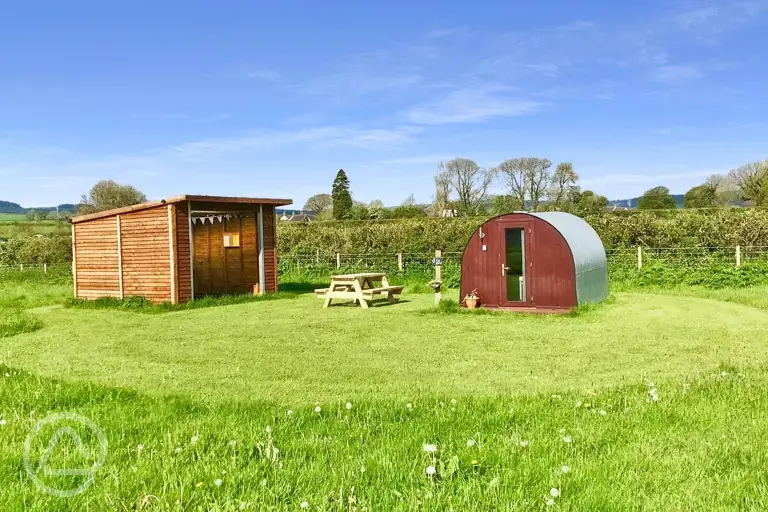 Fox Barn pod with a covered kitchen area at Big Barn Camping
