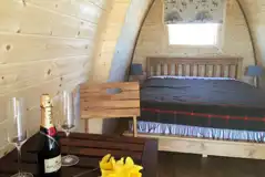 Fully insulated camping pod interior with hired bedding