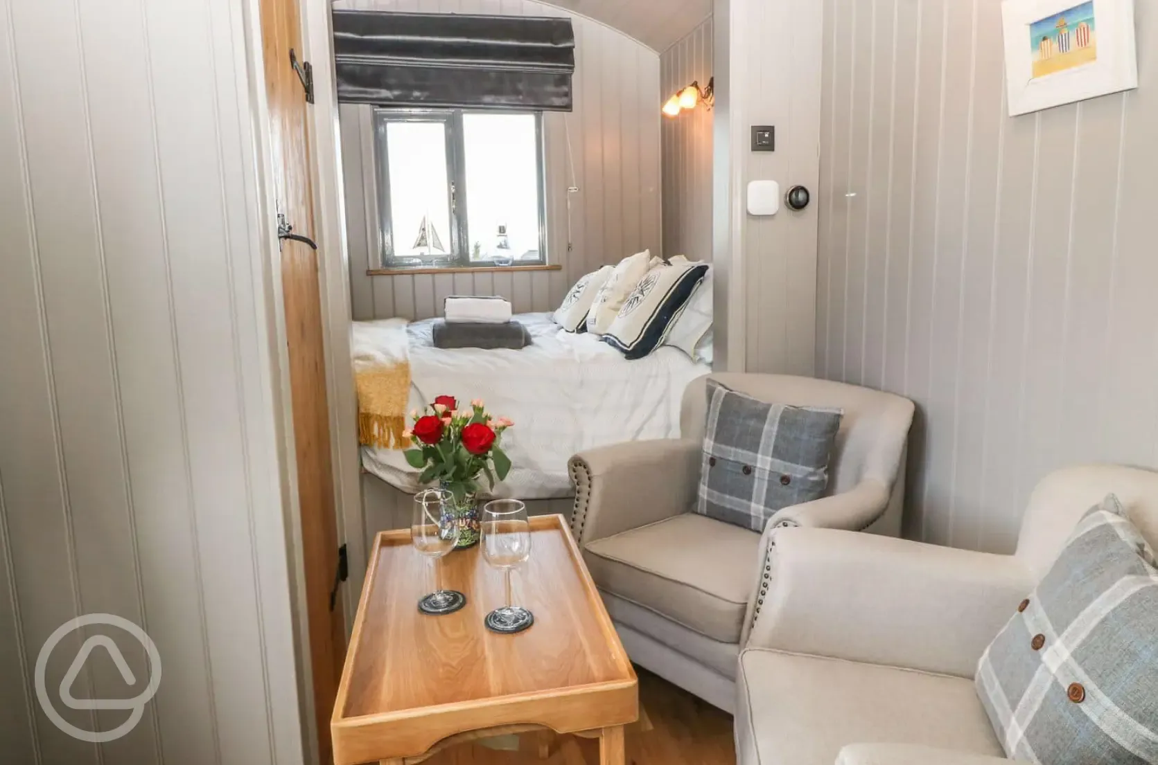 Shepherd's hut double bed and seating area