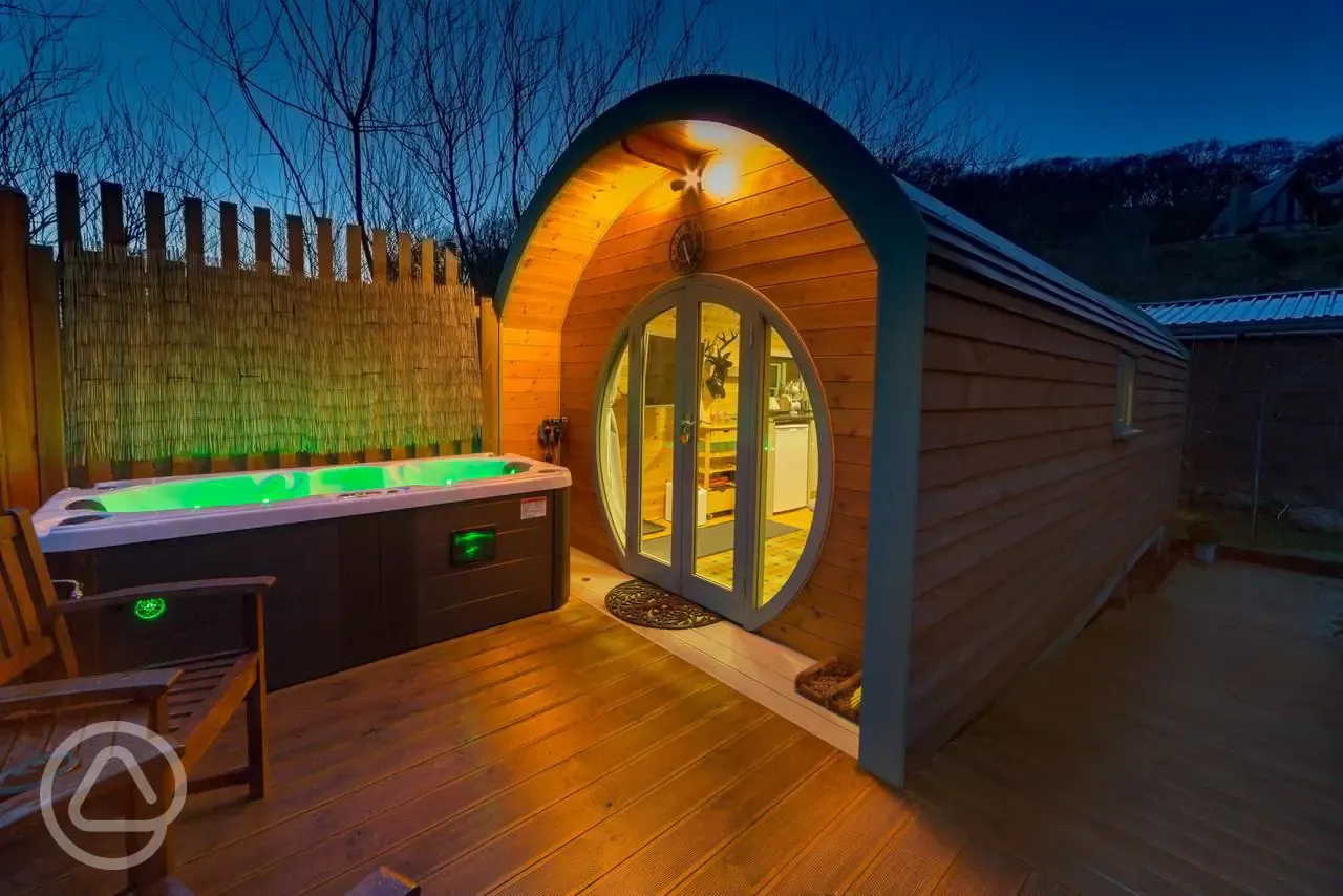 Suilven View ensuite glamping pod at night with decking and hot tub Suilven View ensuite glamping pod at night with decking and hot tub