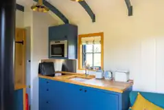 Ensuite shepherd's hut kitchen with hob, microwave, fridge, kettle and toaster