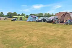 Electric grass tent pitches measuring 10m by 10m