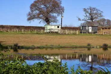 Shepherd's huts by the pond