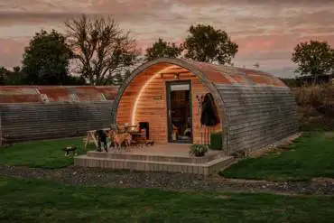 Luxury glamping pods at dusk