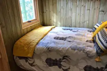 Bed inside en-suite hut