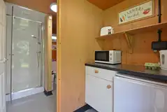 Pod private kitchen area with a microwave, fridge and fridge/freezer