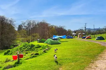 Non electric grass pitches at Caldbeck Camping with space for a parked car