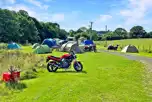 Motorcycles and tents on the non electric grass pitches