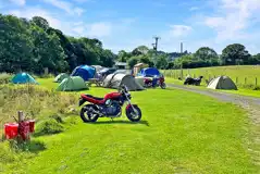 Motorcycles and tents on the non electric grass pitches
