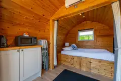 Camping pods with a double bed, kitchen unit and sofa bed