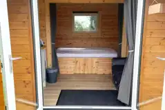 Camping pod interior with a double bed (bring own bedding)