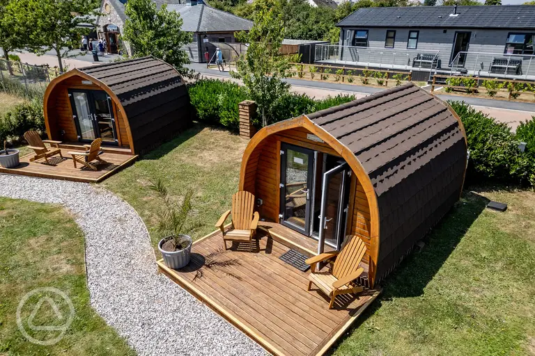 Camping pods with a deck area with table and chairs