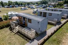 Shepherd's huts with raised decking area and seating