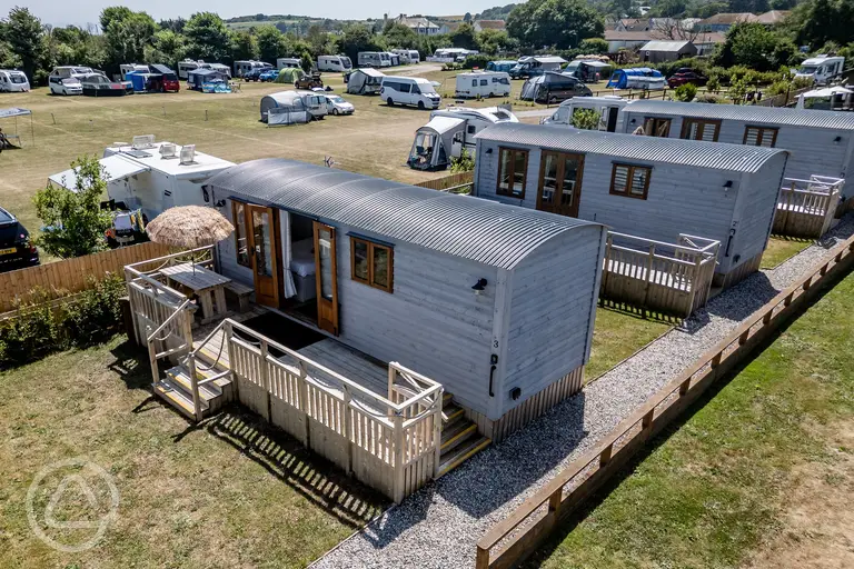 Shepherd's huts with raised decking area and seating