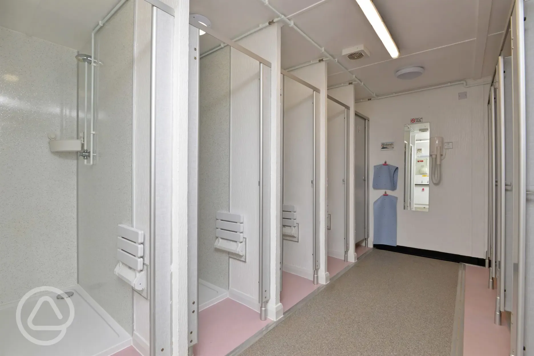 Showers with a stool and shelf for toiletries at Oakmoor Touring Park